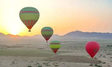 Hot air balloon floating over the countryside near Marrakech