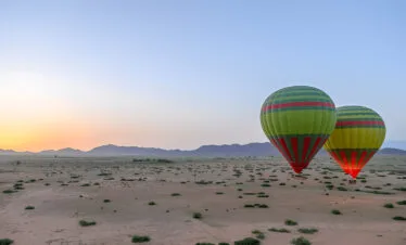 Two hot air balloons over the Marrakech countryside