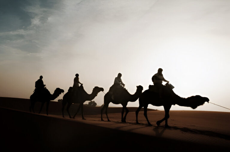A camel caravan crossing the dunes of Erg Chegaga in southern Morocco