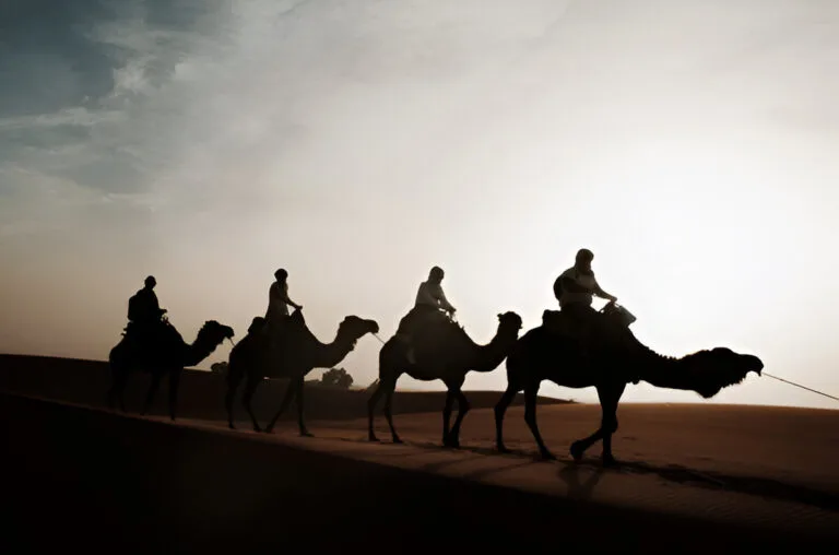 A camel caravan crossing the dunes of Erg Chegaga in southern Morocco