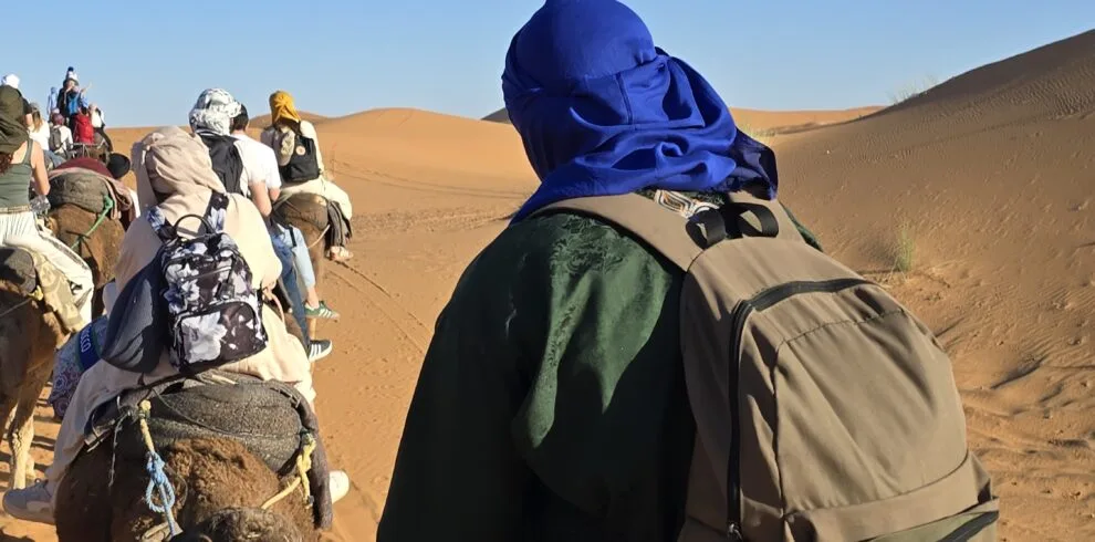 Camel trek crossing the dunes at Merzouga, Morocco